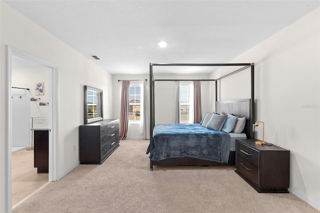 616 Griffon Ave, Lake Alfred, FL 33850 - bedroom with light colored carpet, baseboards, and connected bathroom