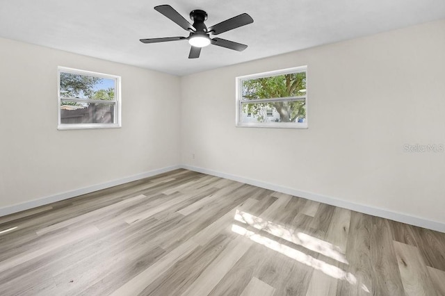 4119 Beacon Square Dr, Holiday, FL 34691 - spare room with plenty of natural light, wood finished floors, baseboards, and ceiling fan