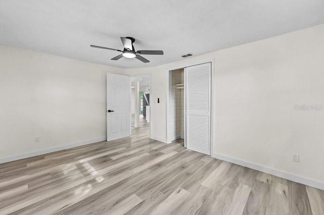 4119 Beacon Square Dr, Holiday, FL 34691 - unfurnished bedroom with a closet, light wood finished floors, baseboards, and a ceiling fan
