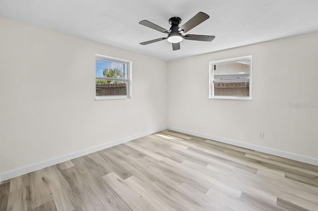 4119 Beacon Square Dr, Holiday, FL 34691 - spare room featuring wood finished floors, baseboards, and ceiling fan