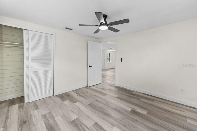 4119 Beacon Square Dr, Holiday, FL 34691 - unfurnished bedroom with light wood-style floors and baseboards