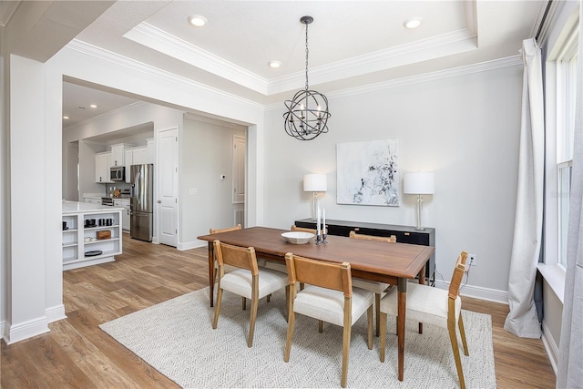 5 Heuchera Ct E, Homosassa, FL 34446 - dining room featuring light wood-style floors, crown molding, a tray ceiling, baseboards, and recessed lighting