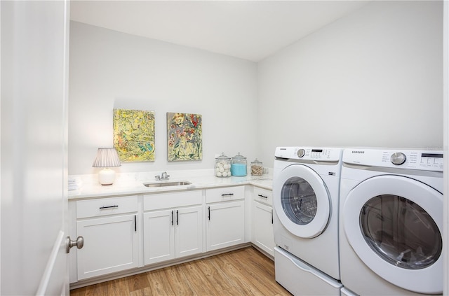 5 Heuchera Ct E, Homosassa, FL 34446 - clothes washing area with washer and dryer, cabinet space, and light wood finished floors