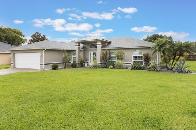 2113 Kirkland Lake Dr, Auburndale, FL 33823 - view of front of home featuring stucco siding, a garage, concrete driveway, and a front yard