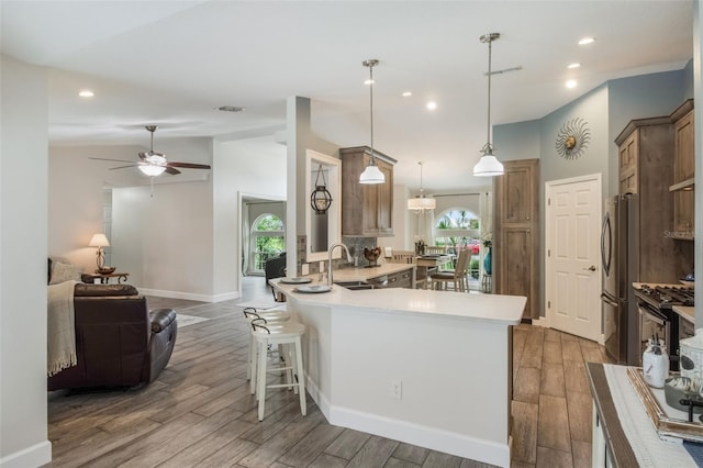 2113 Kirkland Lake Dr, Auburndale, FL 33823 - kitchen with freestanding refrigerator, wood finished floors, a peninsula, a ceiling fan, and recessed lighting