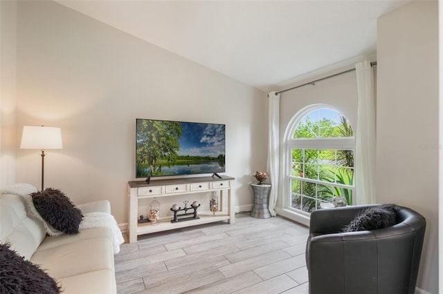 2113 Kirkland Lake Dr, Auburndale, FL 33823 - living room featuring lofted ceiling, wood finished floors, and baseboards