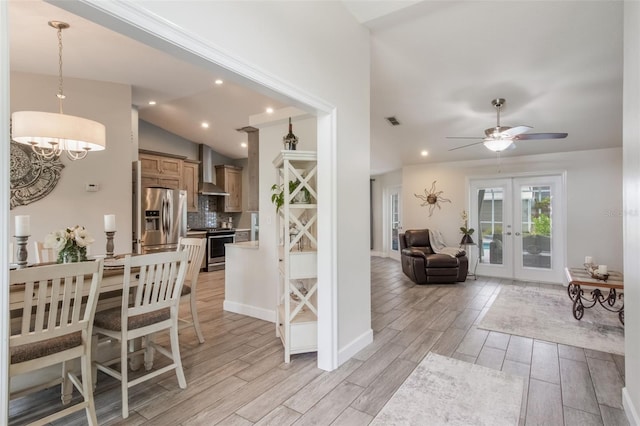 2113 Kirkland Lake Dr, Auburndale, FL 33823 - interior space with french doors, vaulted ceiling, ceiling fan, light wood-style flooring, and a chandelier