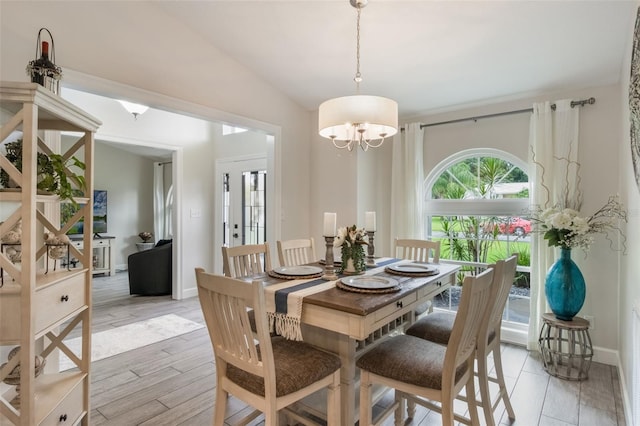 2113 Kirkland Lake Dr, Auburndale, FL 33823 - dining space featuring a chandelier, baseboards, vaulted ceiling, and light wood-style flooring