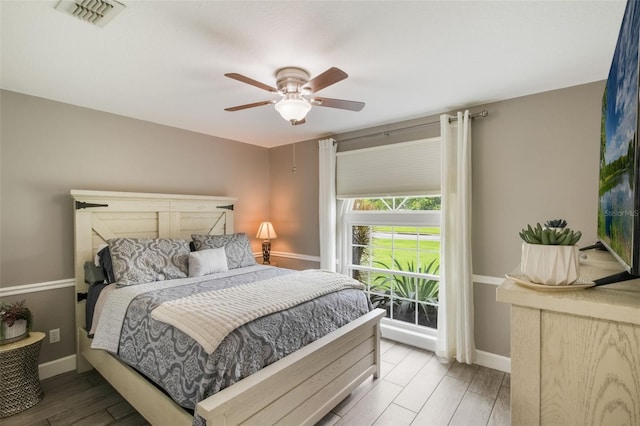 2113 Kirkland Lake Dr, Auburndale, FL 33823 - bedroom with wood finished floors, baseboards, and a ceiling fan