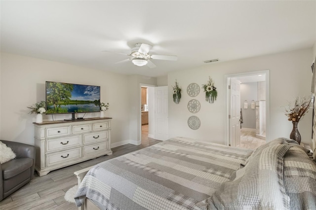 2113 Kirkland Lake Dr, Auburndale, FL 33823 - bedroom featuring light wood-type flooring, baseboards, a ceiling fan, and ensuite bath