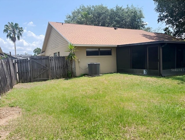 1606 Red Clover Ct, Orlando, FL 32825 - rear view of house with a sunroom, a fenced backyard, a shingled roof, and stucco siding