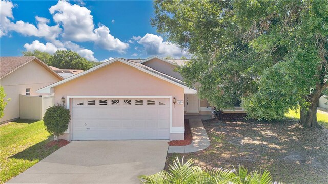 1614 Christa Ct, Saint Cloud, FL 34772 - view of front of home with driveway, an attached garage, and stucco siding