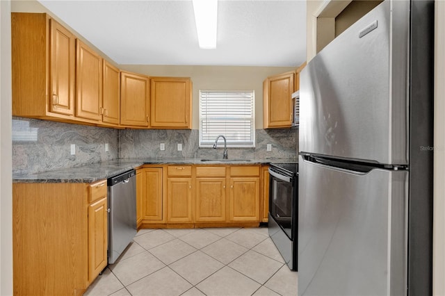 1614 Christa Ct, Saint Cloud, FL 34772 - kitchen with stainless steel appliances, a sink, backsplash, dark stone countertops, and light tile patterned flooring