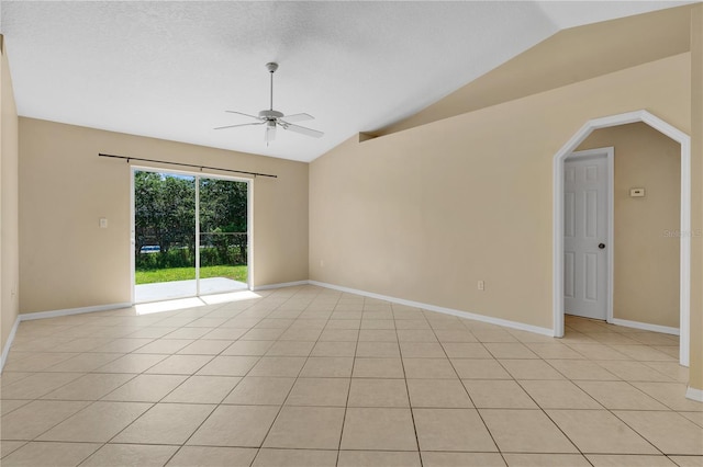 1614 Christa Ct, Saint Cloud, FL 34772 - empty room featuring a ceiling fan, lofted ceiling, baseboards, light tile patterned floors, and arched walkways