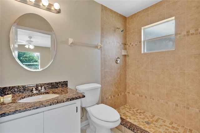 1614 Christa Ct, Saint Cloud, FL 34772 - bathroom with tiled shower, vanity, ceiling fan, and toilet