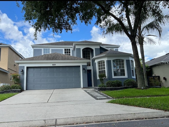 14936 Masthead Landing Cir, Winter Garden, FL 34787 - traditional-style house featuring stucco siding, an attached garage, and driveway