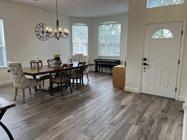 14936 Masthead Landing Cir, Winter Garden, FL 34787 - dining room featuring a chandelier, wood finished floors, and baseboards