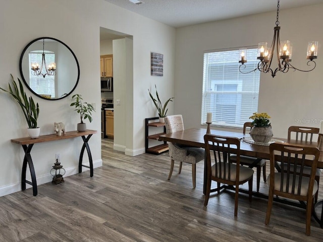14936 Masthead Landing Cir, Winter Garden, FL 34787 - dining room featuring a chandelier, dark wood-style flooring, and baseboards