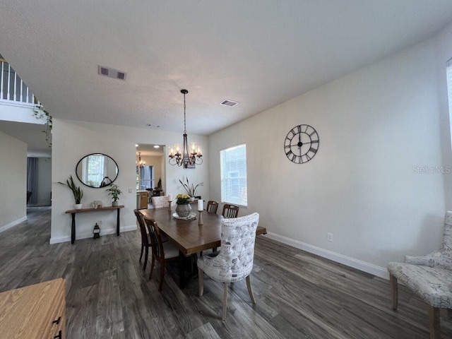 14936 Masthead Landing Cir, Winter Garden, FL 34787 - dining room featuring dark wood finished floors, a chandelier, and baseboards