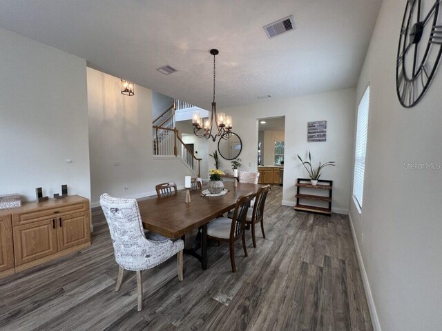 14936 Masthead Landing Cir, Winter Garden, FL 34787 - dining space featuring a chandelier, wood finished floors, stairs, and baseboards