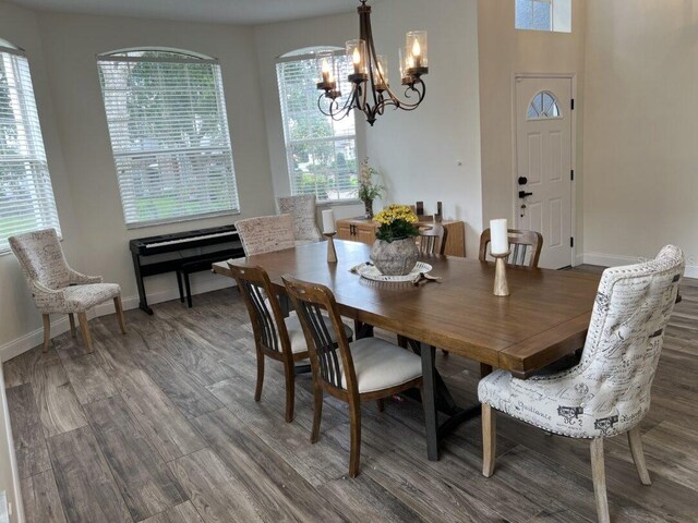14936 Masthead Landing Cir, Winter Garden, FL 34787 - dining area featuring a chandelier, wood finished floors, plenty of natural light, and baseboards