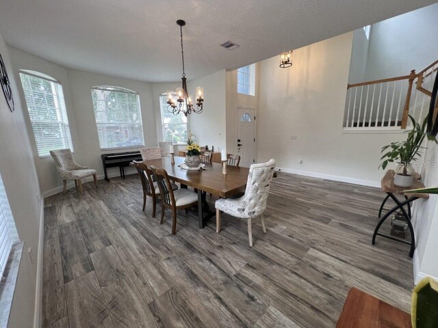 14936 Masthead Landing Cir, Winter Garden, FL 34787 - dining area featuring healthy amount of natural light, a chandelier, and dark wood-style floors