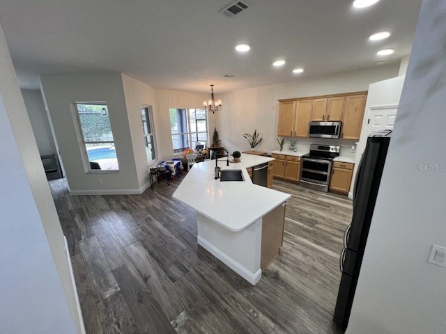 14936 Masthead Landing Cir, Winter Garden, FL 34787 - kitchen featuring stainless steel appliances, a sink, recessed lighting, dark wood-type flooring, and a chandelier