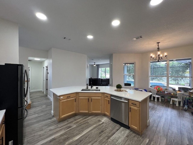 14936 Masthead Landing Cir, Winter Garden, FL 34787 - kitchen featuring dishwasher, freestanding refrigerator, a sink, light wood-type flooring, and light countertops