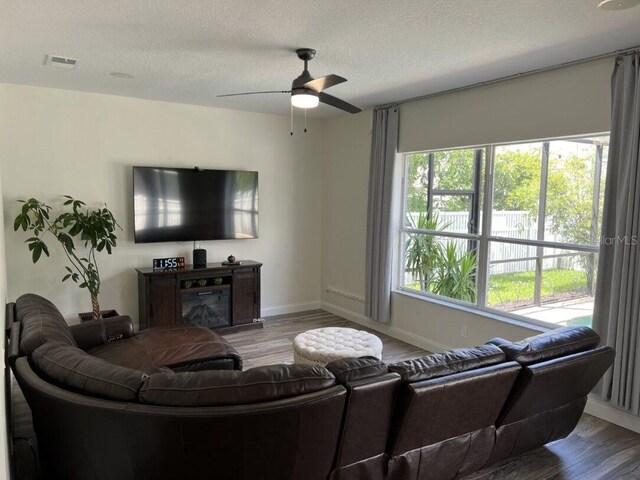 14936 Masthead Landing Cir, Winter Garden, FL 34787 - living area with wood finished floors, ceiling fan, a textured ceiling, and baseboards