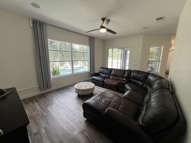 14936 Masthead Landing Cir, Winter Garden, FL 34787 - living area featuring wood finished floors, a ceiling fan, baseboards, and a textured ceiling