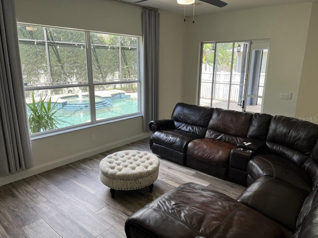 14936 Masthead Landing Cir, Winter Garden, FL 34787 - living area featuring ceiling fan, wood finished floors, and baseboards