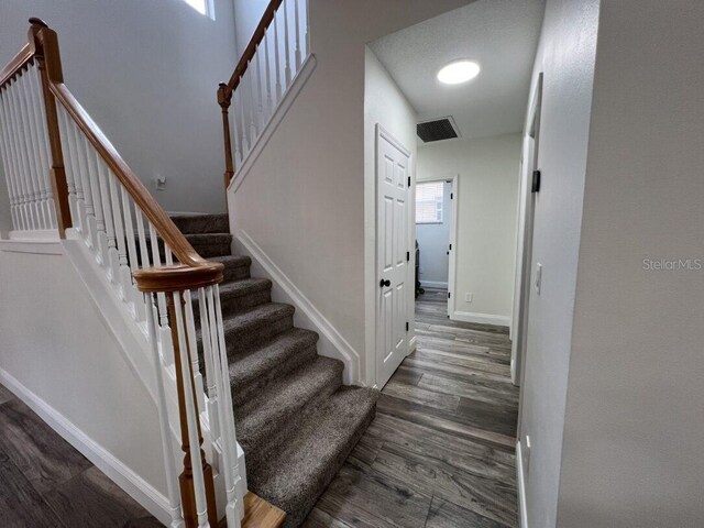14936 Masthead Landing Cir, Winter Garden, FL 34787 - stairway featuring wood finished floors and baseboards