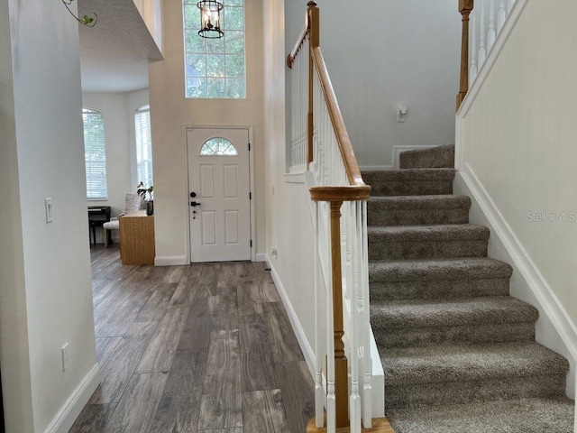 14936 Masthead Landing Cir, Winter Garden, FL 34787 - entrance foyer featuring stairway, dark wood finished floors, a high ceiling, and baseboards