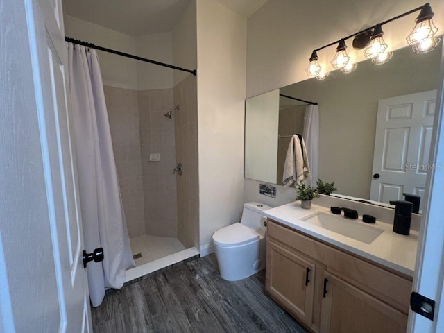 14936 Masthead Landing Cir, Winter Garden, FL 34787 - bathroom featuring vanity, toilet, wood finished floors, and tiled shower