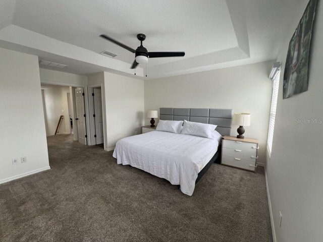 14936 Masthead Landing Cir, Winter Garden, FL 34787 - carpeted bedroom featuring a raised ceiling, baseboards, and ceiling fan