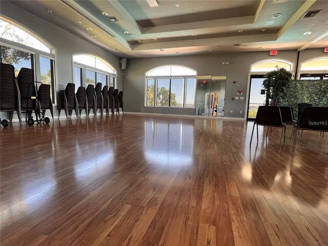 14936 Masthead Landing Cir, Winter Garden, FL 34787 - gym featuring a raised ceiling, wood finished floors, baseboards, and recessed lighting
