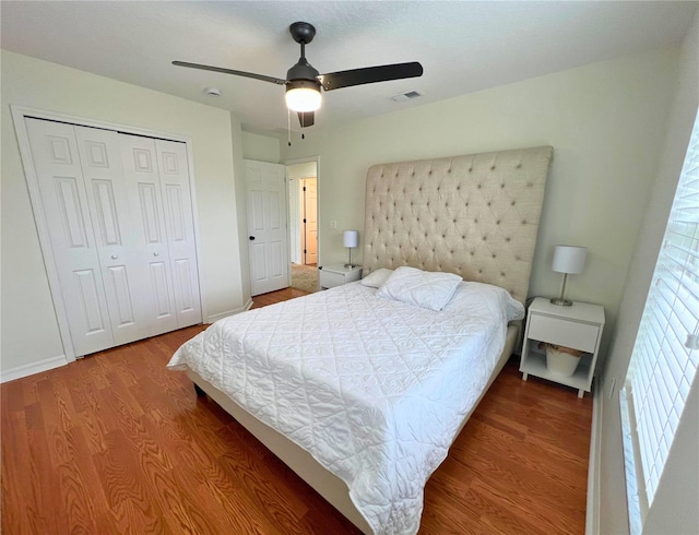14936 Masthead Landing Cir, Winter Garden, FL 34787 - bedroom with wood finished floors, a closet, a ceiling fan, and baseboards