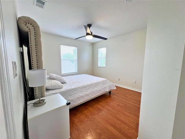 14936 Masthead Landing Cir, Winter Garden, FL 34787 - bedroom with wood finished floors, baseboards, and ceiling fan