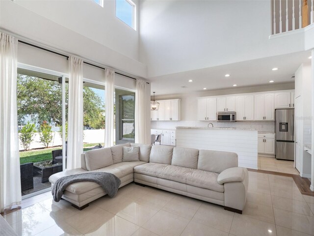 13156 Hatherton Cir, Orlando, FL 32832 - living area featuring a towering ceiling, recessed lighting, and light tile patterned flooring