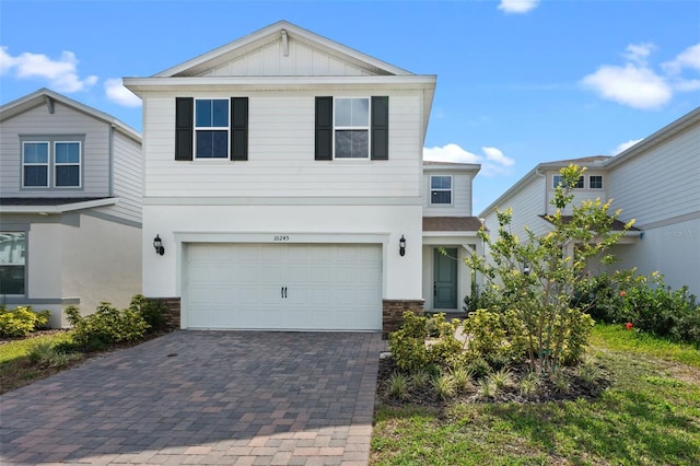 10245 Park Estates Ave, Orlando, FL 32836 - view of front of house with decorative driveway, a garage, board and batten siding, and stucco siding