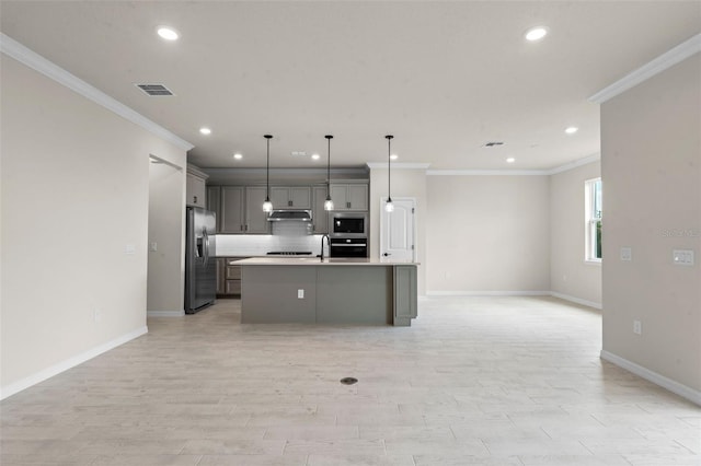 10245 Park Estates Ave, Orlando, FL 32836 - kitchen with appliances with stainless steel finishes, under cabinet range hood, open floor plan, recessed lighting, and baseboards