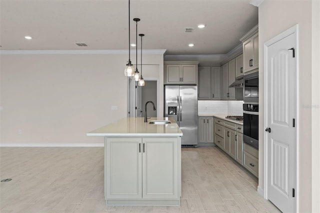 10245 Park Estates Ave, Orlando, FL 32836 - kitchen with gray cabinets, appliances with stainless steel finishes, a sink, a kitchen island with sink, and ornamental molding