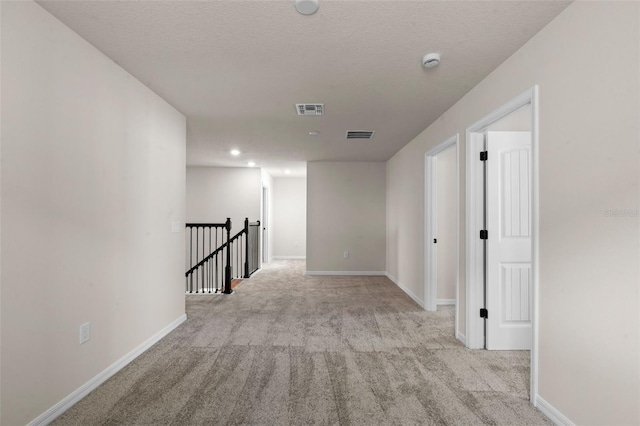 10245 Park Estates Ave, Orlando, FL 32836 - hall with an upstairs landing, carpet, baseboards, a textured ceiling, and recessed lighting