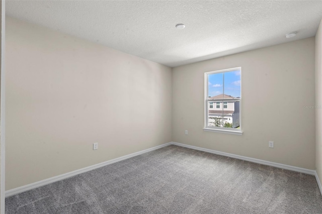 10245 Park Estates Ave, Orlando, FL 32836 - spare room featuring carpet, a textured ceiling, baseboards, and a smoke detector