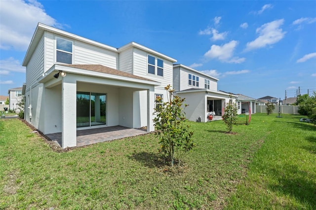 10245 Park Estates Ave, Orlando, FL 32836 - back of property with a patio, stucco siding, a lawn, and a shingled roof