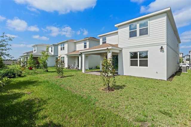10245 Park Estates Ave, Orlando, FL 32836 - back of property featuring a yard, a patio, and stucco siding