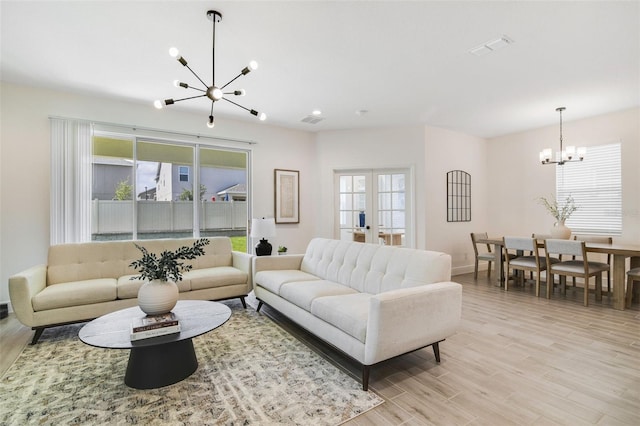 14655 Erice Ave, Clermont, FL 34714 - living room with a chandelier, healthy amount of natural light, light wood-style floors, and baseboards