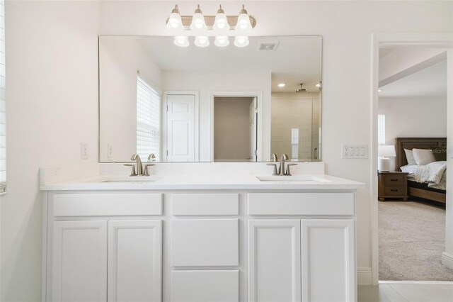 14655 Erice Ave, Clermont, FL 34714 - bathroom featuring double vanity, tiled shower, and connected bathroom