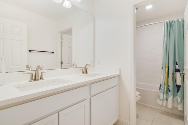 14655 Erice Ave, Clermont, FL 34714 - bathroom with double vanity, shower / bathtub combination with curtain, toilet, tile patterned floors, and recessed lighting