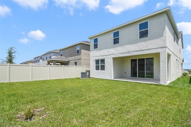 14655 Erice Ave, Clermont, FL 34714 - back of house featuring stucco siding, central AC unit, and a patio